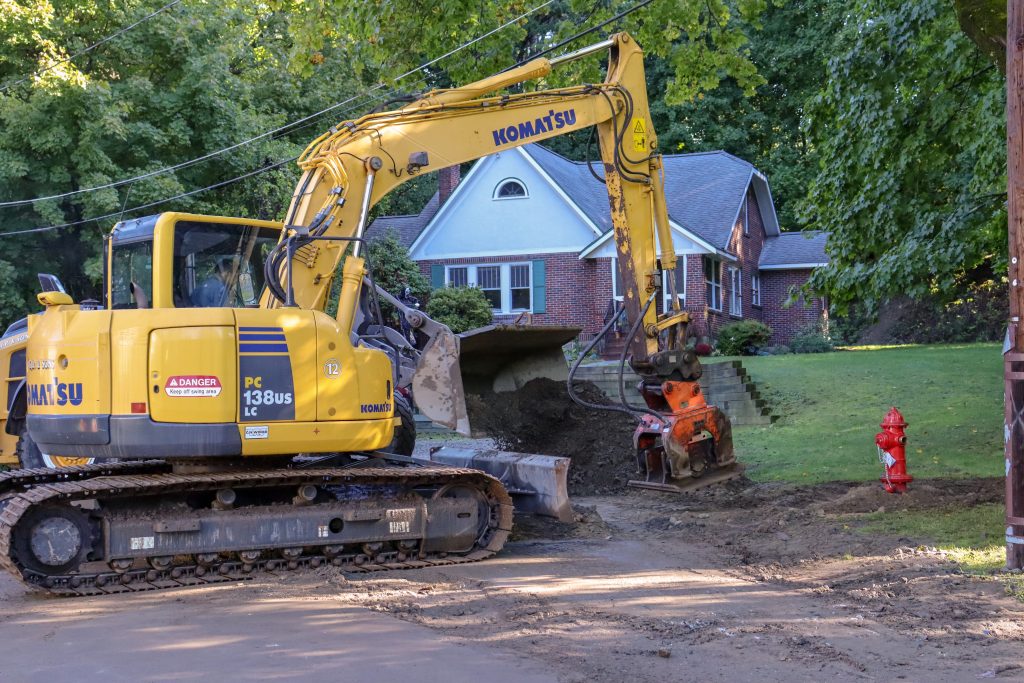 Image of an excavator compacting fill around a new fire hydrant