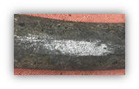Image of a scratched lead pipe. When lead it scratched a dull silver-gray color appears (like this photo)